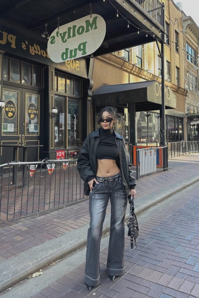 Black Leather Bomber Jacket + Black Mock Neck Crop Top + Faded Grey Low-Rise Flared Jeans + Black Pointed Boots