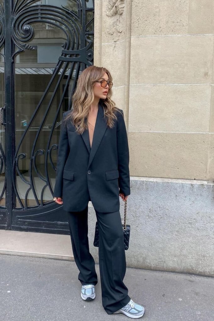 Black Oversized Pantsuit + Black Quilted Handbag + Grey and Blue Athletic Sneakers