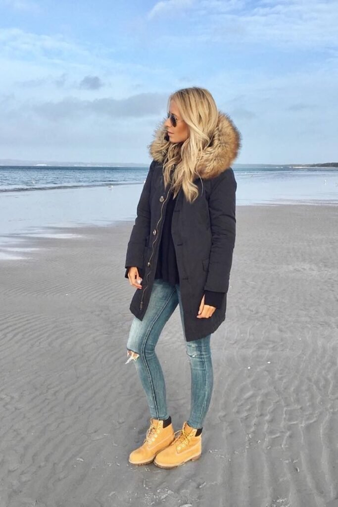 Black Parka with Fur Hood + Ripped Skinny Jeans + Classic Tan Work Boots