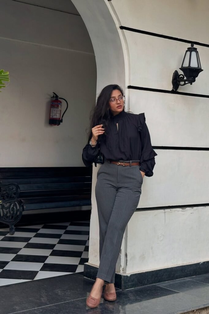 Black Ruffle-Sleeve High-Neck Blouse + Grey Pinstripe Tapered Trousers + Mauve Pointed Flats