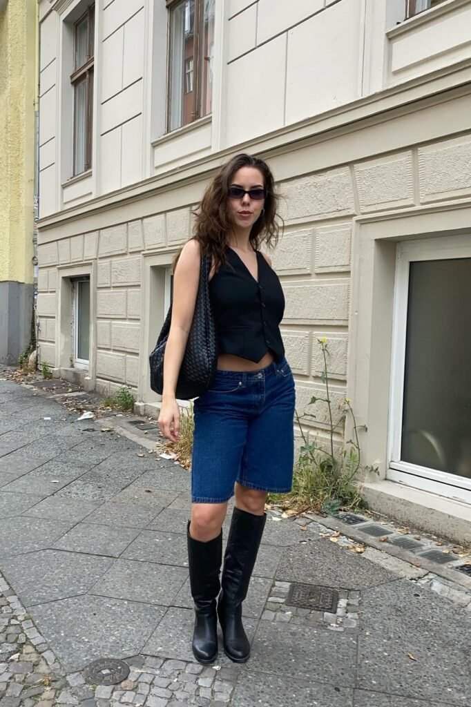 Black Tailored Vest + Dark Wash Denim Bermuda Shorts + Black Knee-High Boots