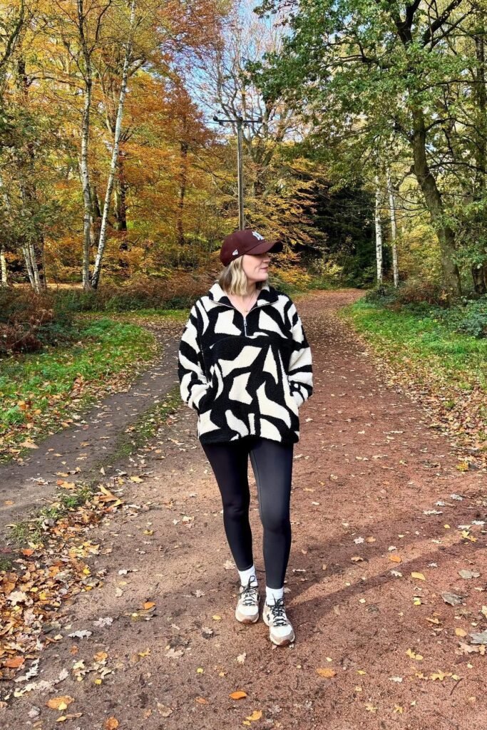 Black and White Abstract Print Fleece Quarter-Zip + Black Leggings + White Socks + Tan and Black Sneakers