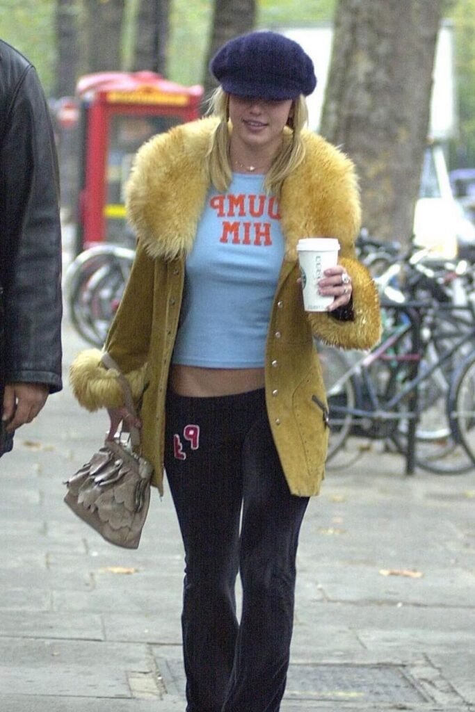 Blue "Dump Him" Graphic Tee + Yellow Faux-Fur Trim Coat + Black Flared Yoga Pants + Navy Baker Boy Hat