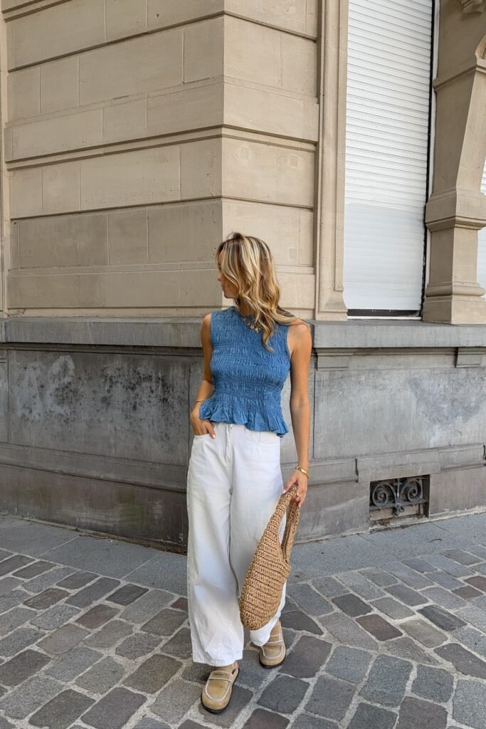 Blue Smocked Sleeveless Top + White Wide-Leg Trousers + Tan Woven Tote + Beige Loafers