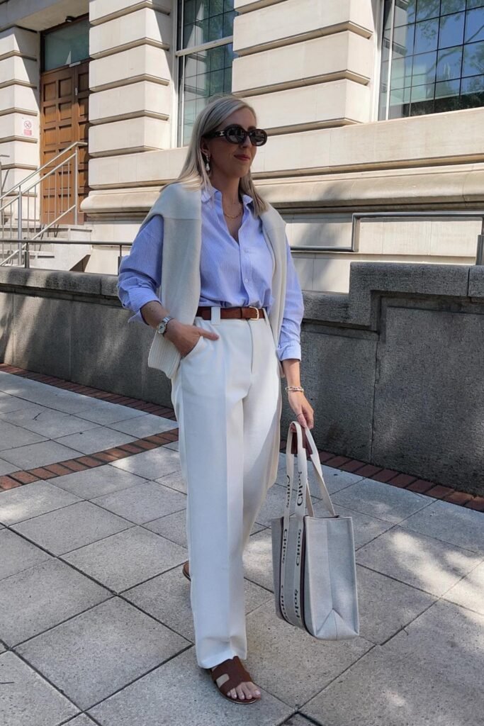 Blue Striped Shirt + White Trousers + White Sweater Over Shoulders