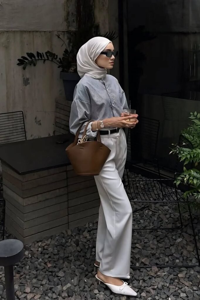 Blue and White Striped Button-down Shirt + White Tailored Trousers + White Pointed-toe Mules + Brown Structured Bucket Bag