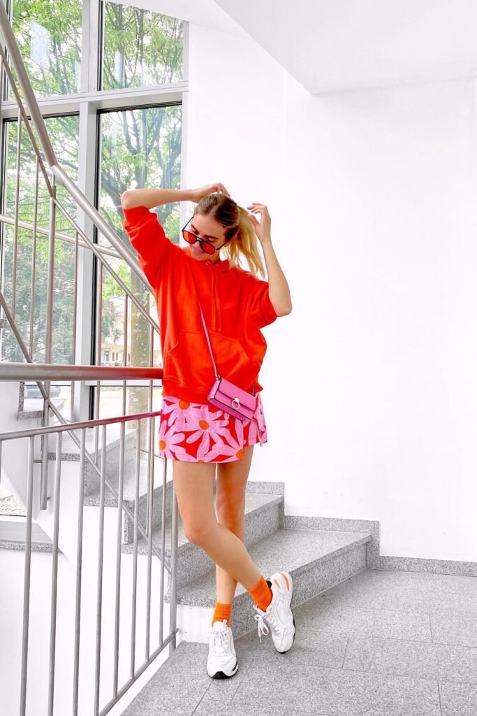 Bright Orange Oversized Hoodie + Pink Floral Mini Skirt + White Sneakers