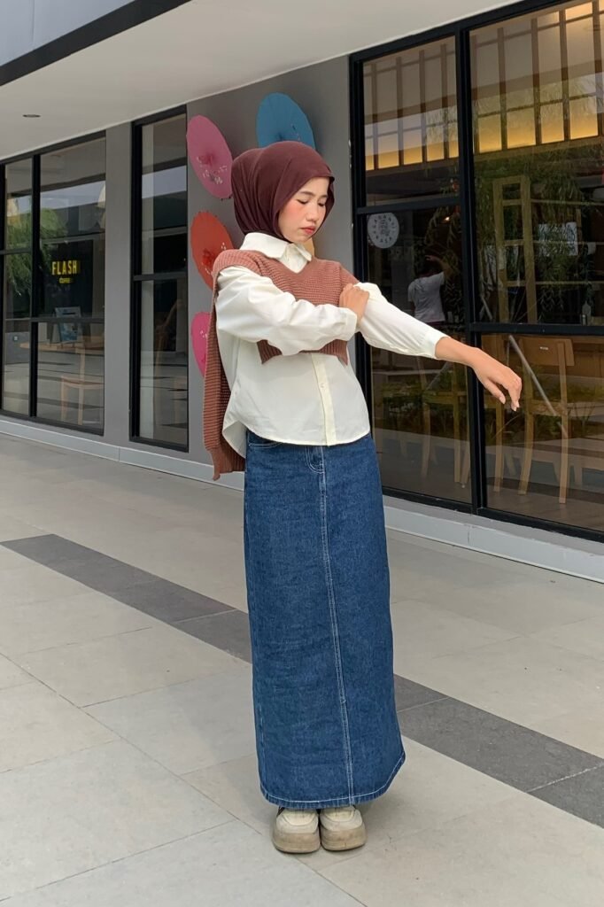 Brown Hijab + White Button-Down Shirt + Brown Cropped Knit Vest + Straight Denim Maxi Skirt + Beige Platform Sneakers