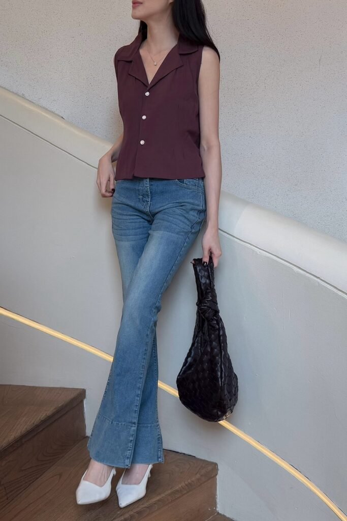 Burgundy Sleeveless Button-Up Shirt + Medium Wash Flare Jeans + White Pointed-Toe Heels