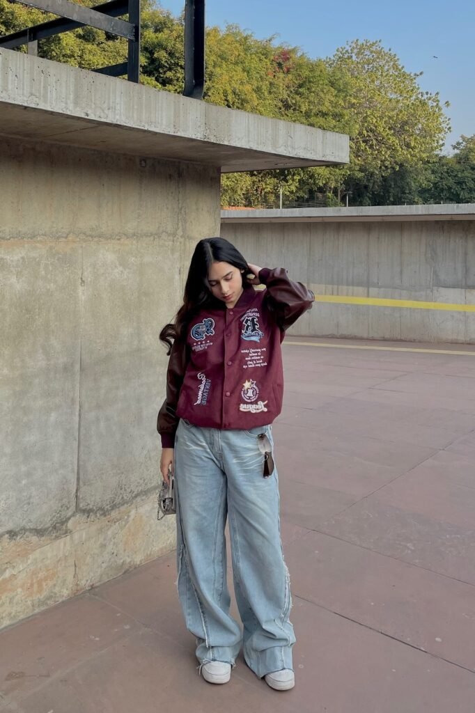Burgundy and Brown Varsity Jacket + Baggy Light Wash Jeans + White Sneakers