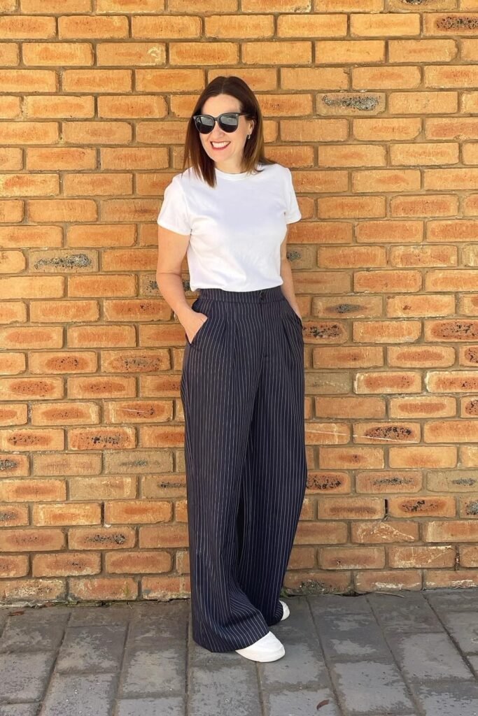 Classic White T-Shirt + Navy Blue Pinstripe Wide-Leg Trousers + White Sneakers