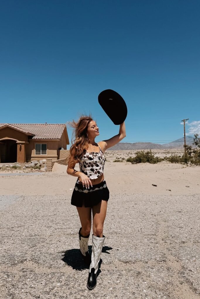 Cow Print Corset Top + Black Micro Mini Skirt + Black and White Cowboy Boots