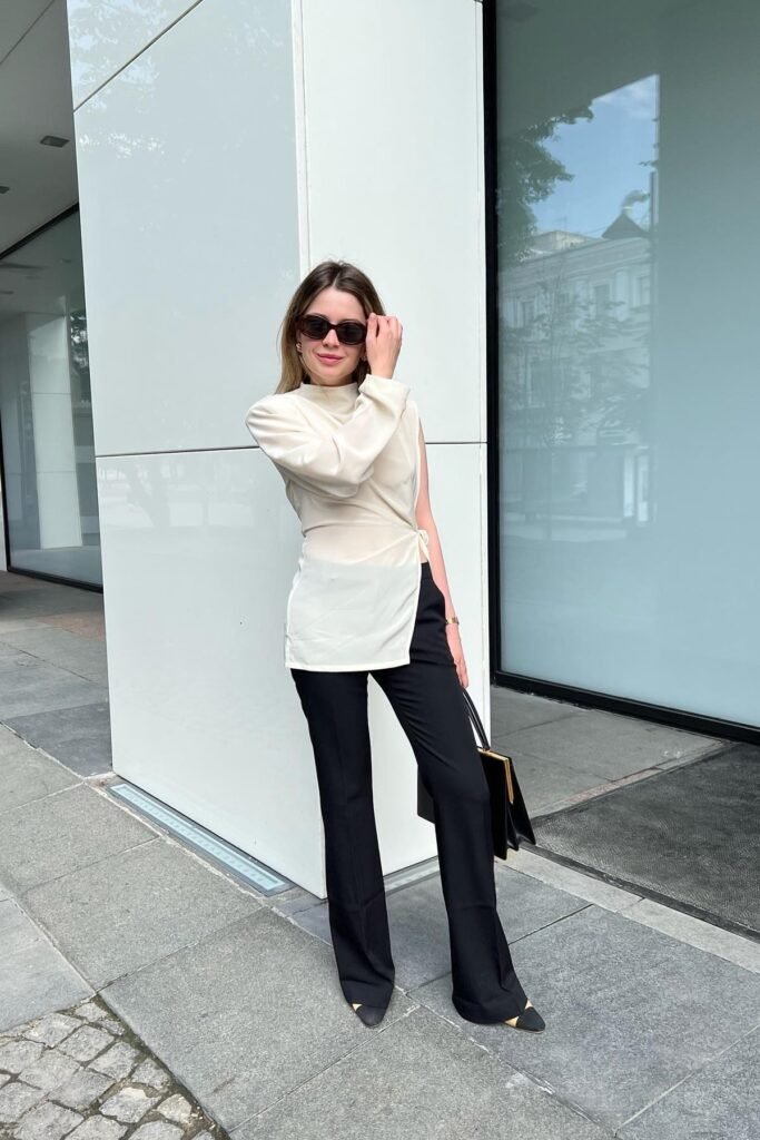 Cream Asymmetric One-Sleeve Blouse + Black Flared Trousers + Black and Tan Pointed Heels