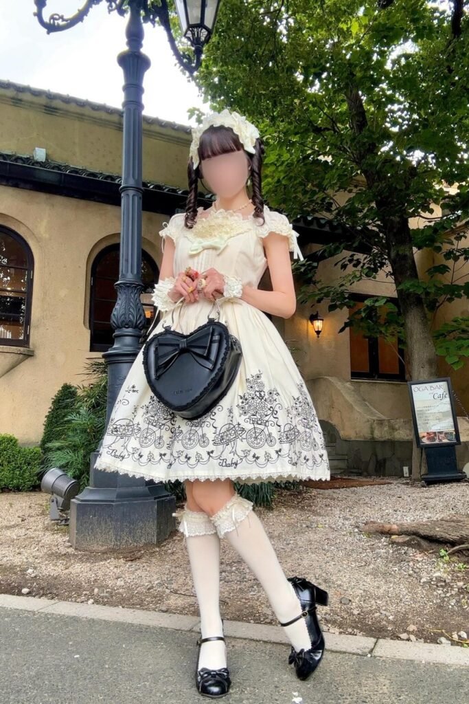 Cream Bicycle-Print Jumper Dress + Cream Lace Headband + Black Heart-Shaped Bag + Black Mary Jane Heels