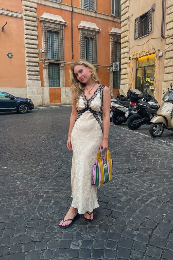 Cream Floral Silk Slip Dress with Black Lace Trim + Black Flip-Flops + Striped Multi-Colored Tote Bag