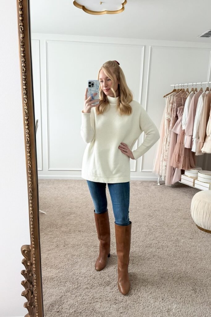 Cream Oversized Turtleneck Sweater + Blue Skinny Jeans + Cognac Leather Knee-High Boots