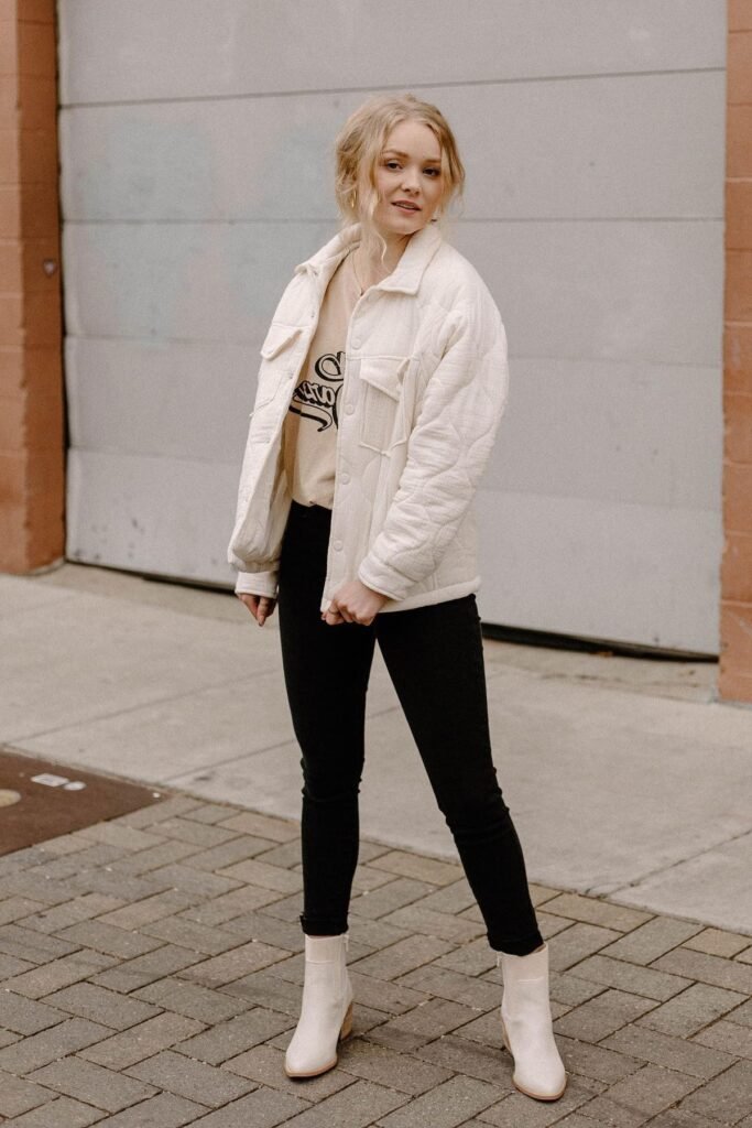 Cream Quilted Shacket + Graphic Tee + Black Skinny Jeans + Cream Pointed-Toe Boots