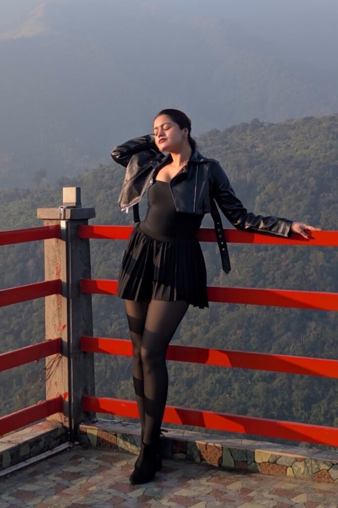 Cropped Black Leather Biker Jacket + Black Bodysuit + Black Pleated Mini Skirt + Sheer Black Tights