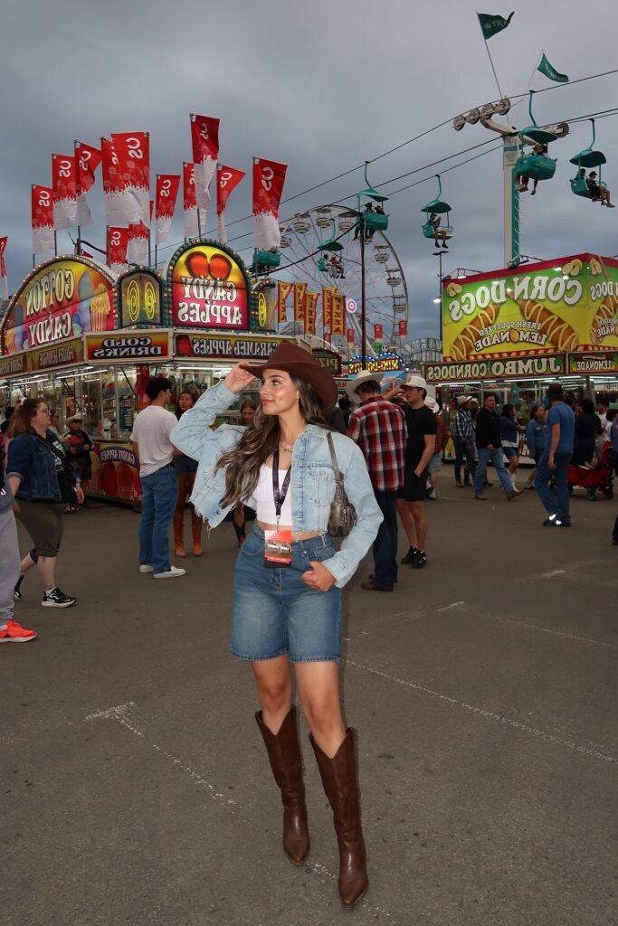 Cropped Denim Jacket + White Crop Top + Denim Bermuda Shorts + Dark Brown Leather Cowboy Boots + Brown Cowboy Hat