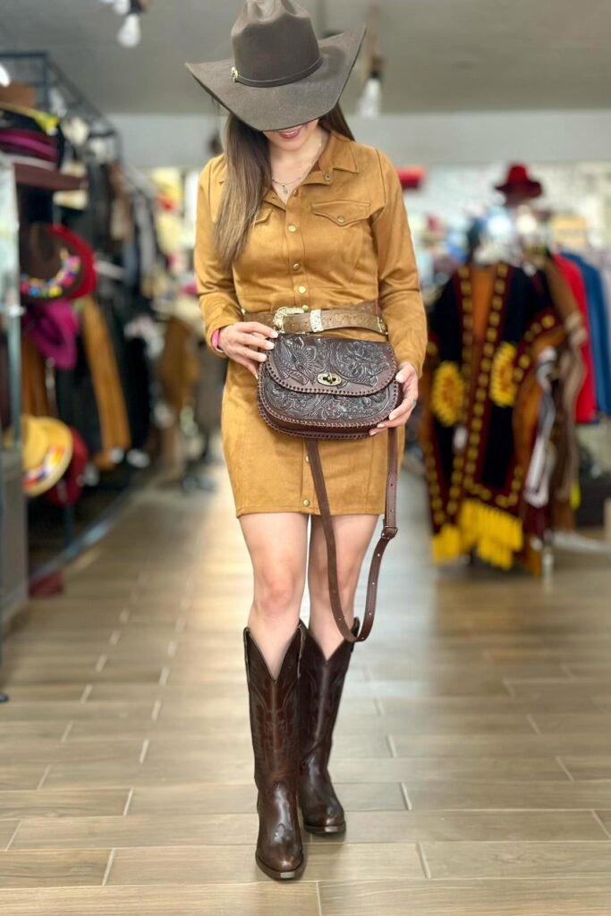 Dark Brown Cowboy Hat + Tan Suede Button-Down Dress + Tooled Leather Belt + Tooled Leather Saddle Bag + Dark Brown Tall Boots