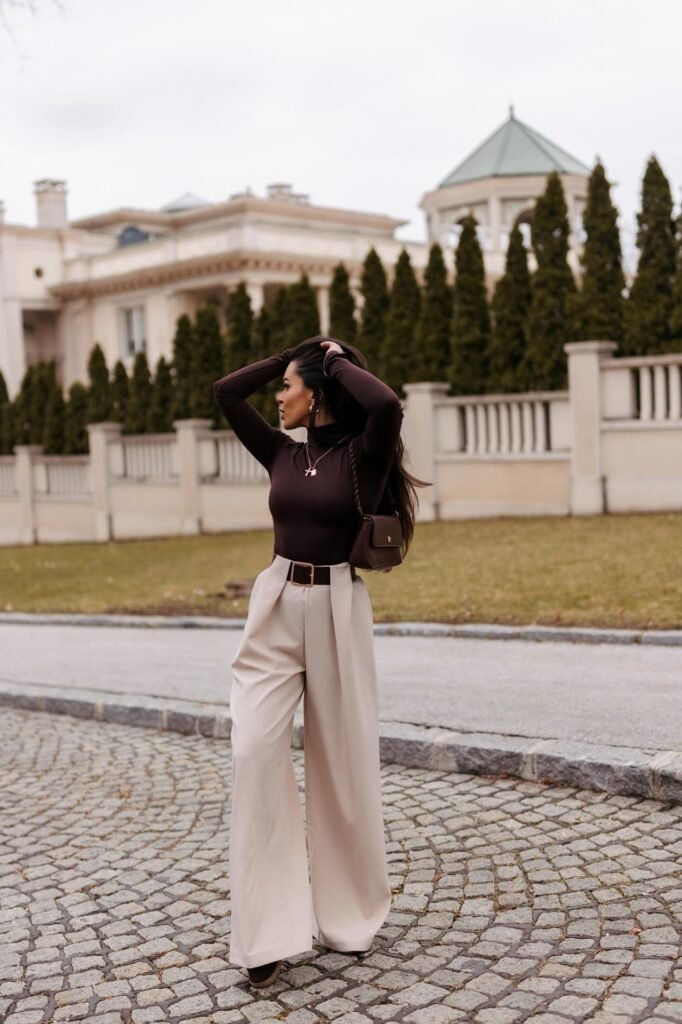 Dark Brown Mock-Neck Top + High-Waisted Beige Wide-Leg Trousers + Brown Leather Handbag