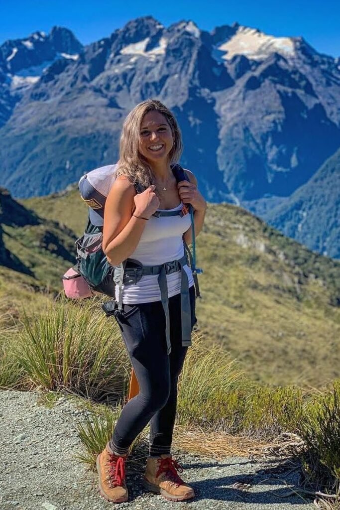 Grey Baseball Cap + White Tank Top + Black Leggings + Tan Hiking Boots