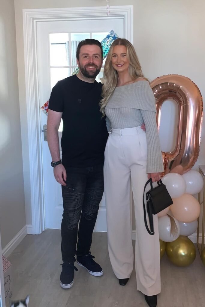 Grey Off-the-Shoulder Ribbed Sweater + Beige High-Waisted Wide-Leg Trousers + Black Square-Toe Boots