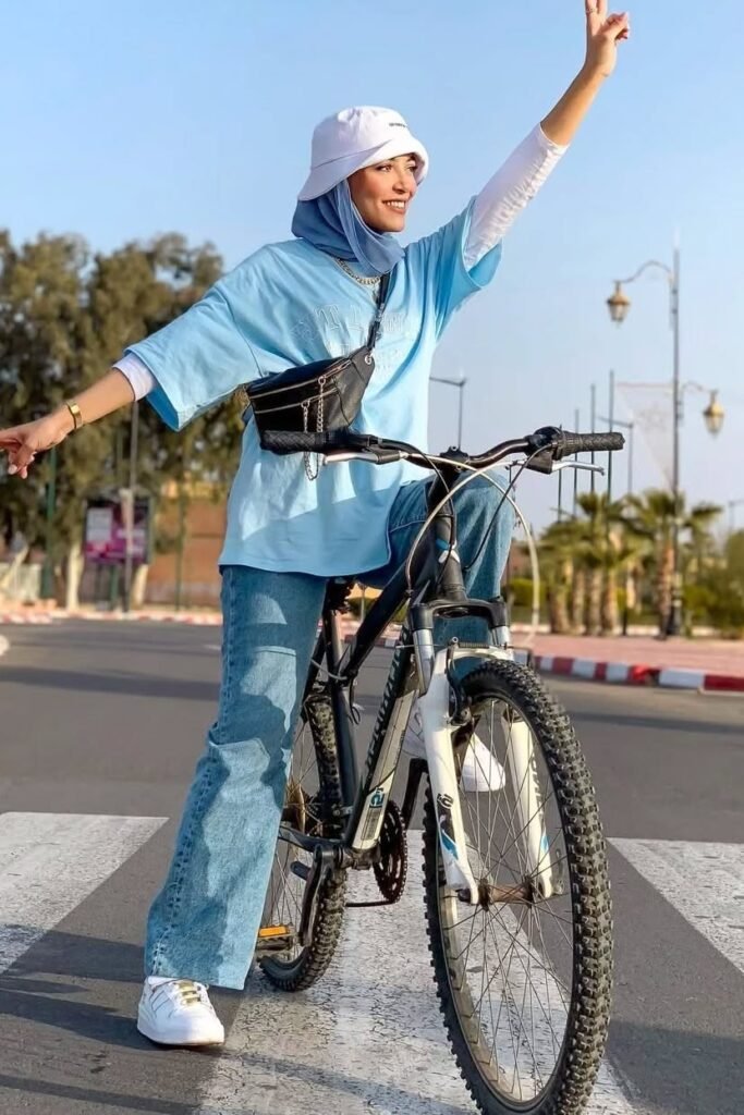 Light Blue Oversized Graphic T-Shirt + Medium Wash Flare Jeans + White Sneakers