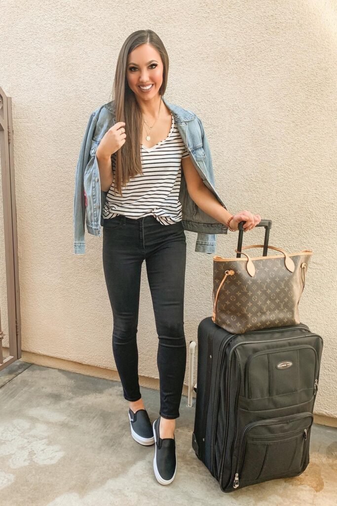 Light Wash Denim Jacket + Black and White Striped V-Neck + Black Skinny Jeans + Black Slip-on Sneakers