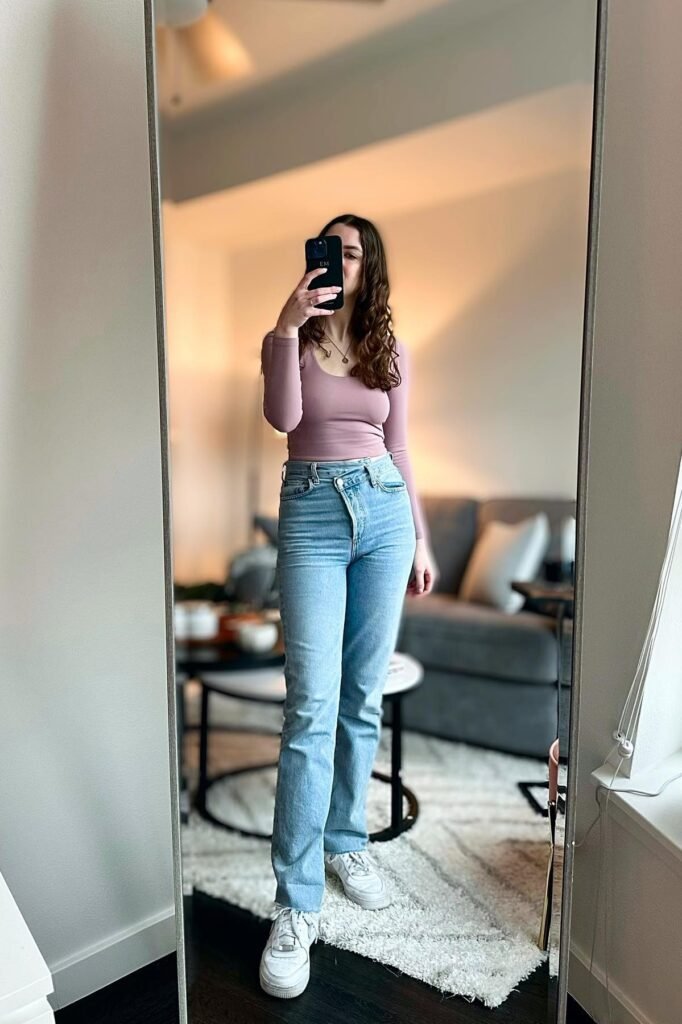 Mauve Long-Sleeve Scoop Neck Top + Light Wash Asymmetrical Waist Jeans + White Sneakers