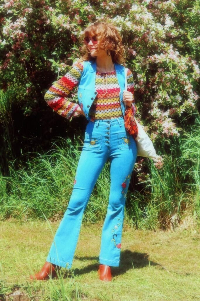 Multi-color Crochet Top + Blue Denim Vest + Embroidered Light Blue Bell-Bottom Jeans + Tan Boots