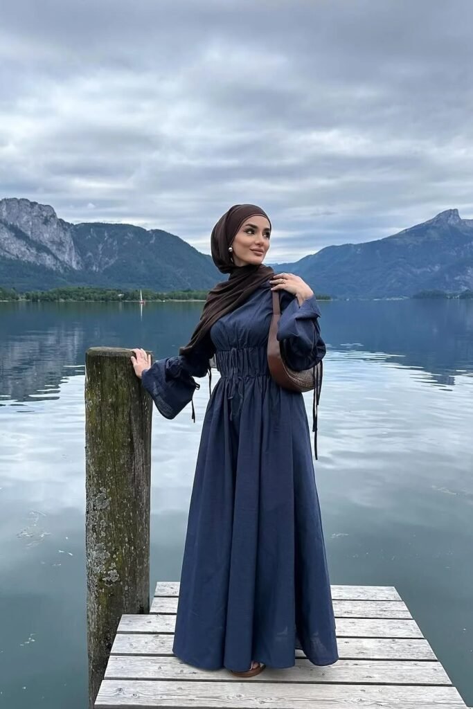 Navy Blue Maxi Dress with Ruched Waist and Bell Sleeves + Dark Brown Hijab + Brown Leather Shoulder Bag