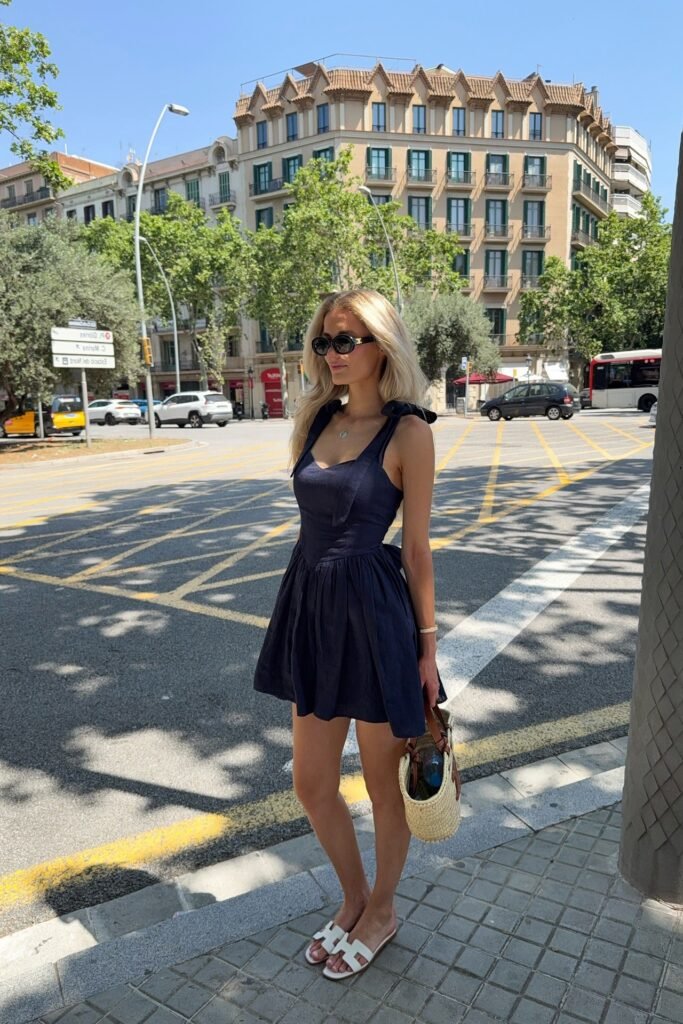 Navy Tie-Strap Mini Dress + White Slide Sandals + Woven Bucket Bag