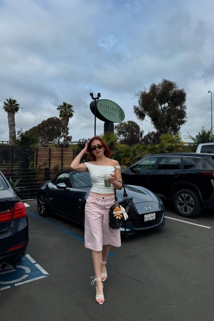 Off-the-Shoulder White Ribbed Top + Pastel Pink Denim Long Shorts + White Lace-Up Heeled Sandals