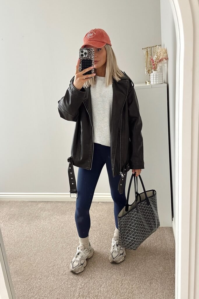Oversized Black Faux-Leather Moto Jacket + Grey T-shirt + Navy Blue Leggings + Cream Socks + Grey Chunky Sneakers