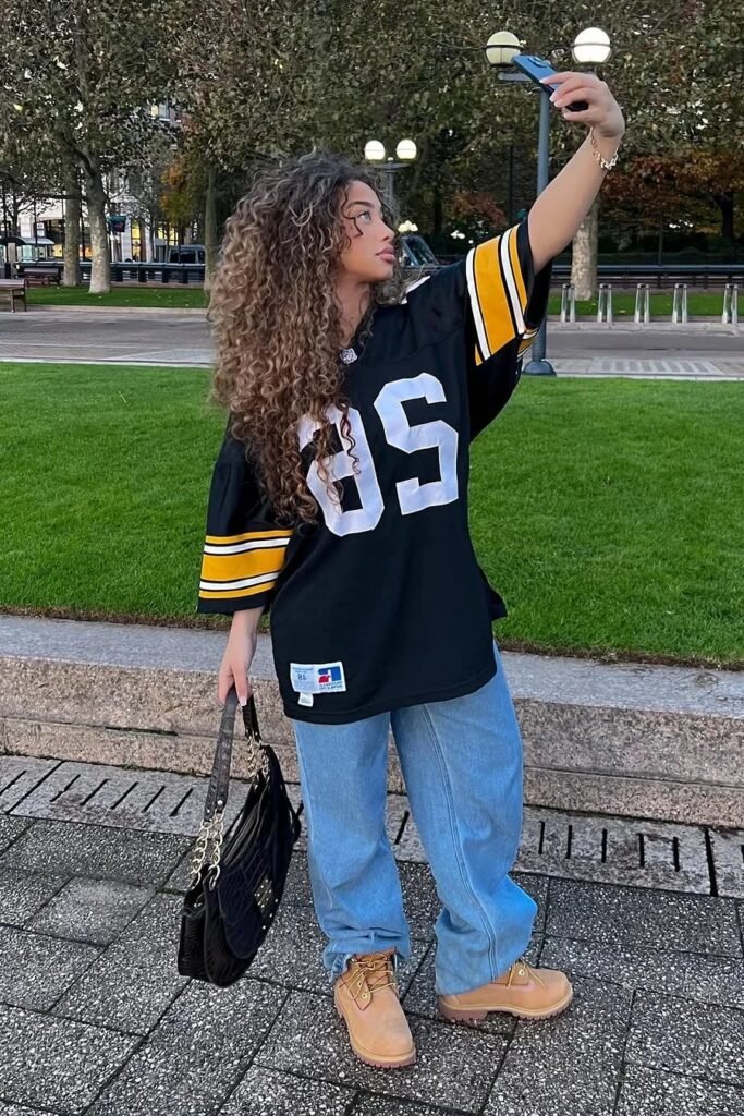 Oversized Black Football Jersey + Baggy Light Wash Jeans + Classic Tan Work Boots