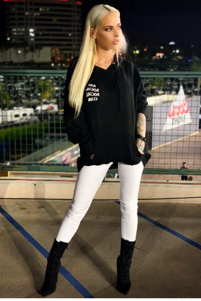 Oversized Black Graphic Hoodie + White Skinny Jeans + Black Suede Lace-Up Boots