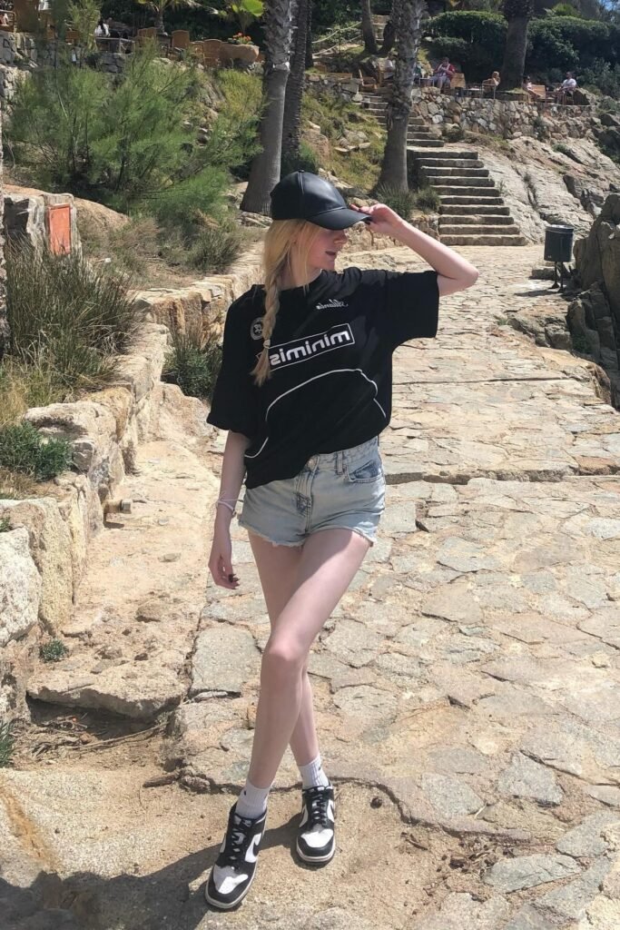 Oversized Black Graphic T-Shirt + Light Wash Denim Cut-offs + Black and White High-Top Sneakers