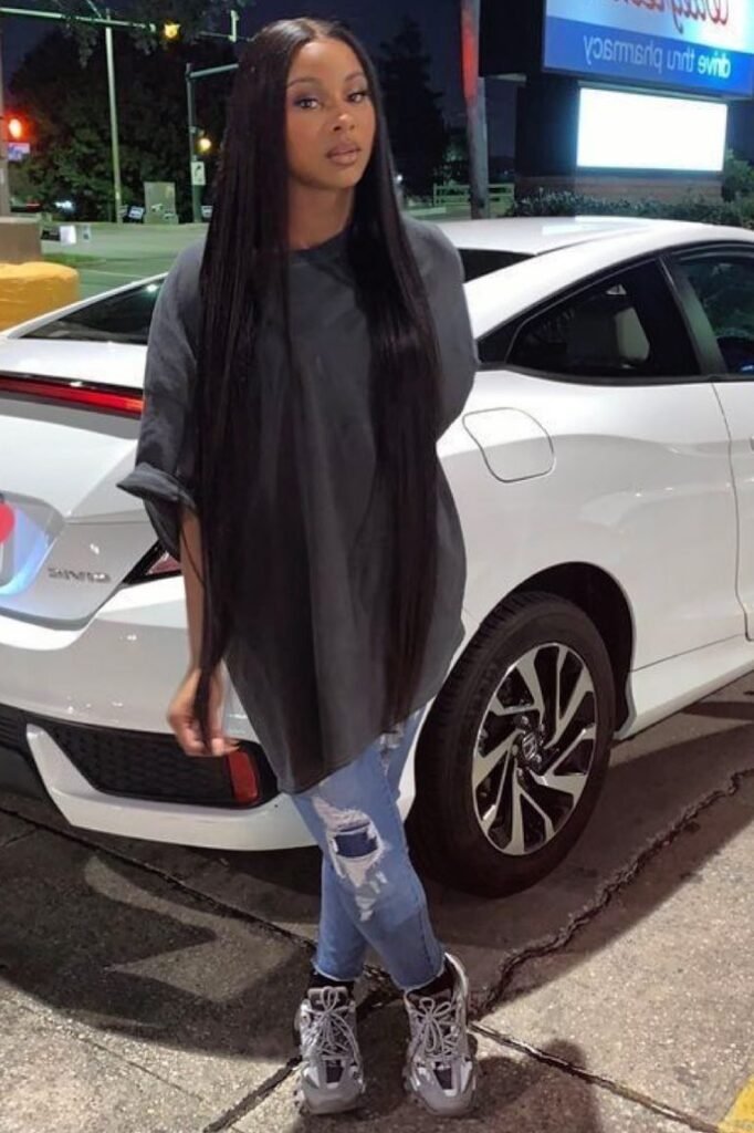 Oversized Charcoal T-Shirt + Distressed Light Blue Skinny Jeans + Grey and White Athletic Sneakers
