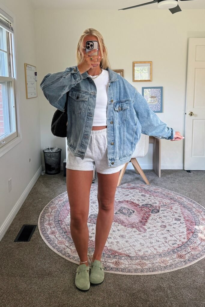 Oversized Denim Jacket + White Crop Top + Grey Sweat Shorts + Sage Green Clogs