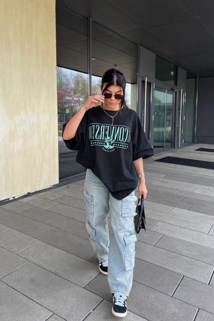 Oversized Graphic T-Shirt + Light Wash Cargo Jeans + Black and White Sneakers