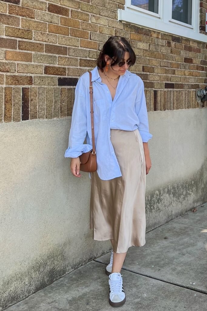 Oversized Light Blue Button-Down + Champagne Satin Midi Skirt + White Sneakers