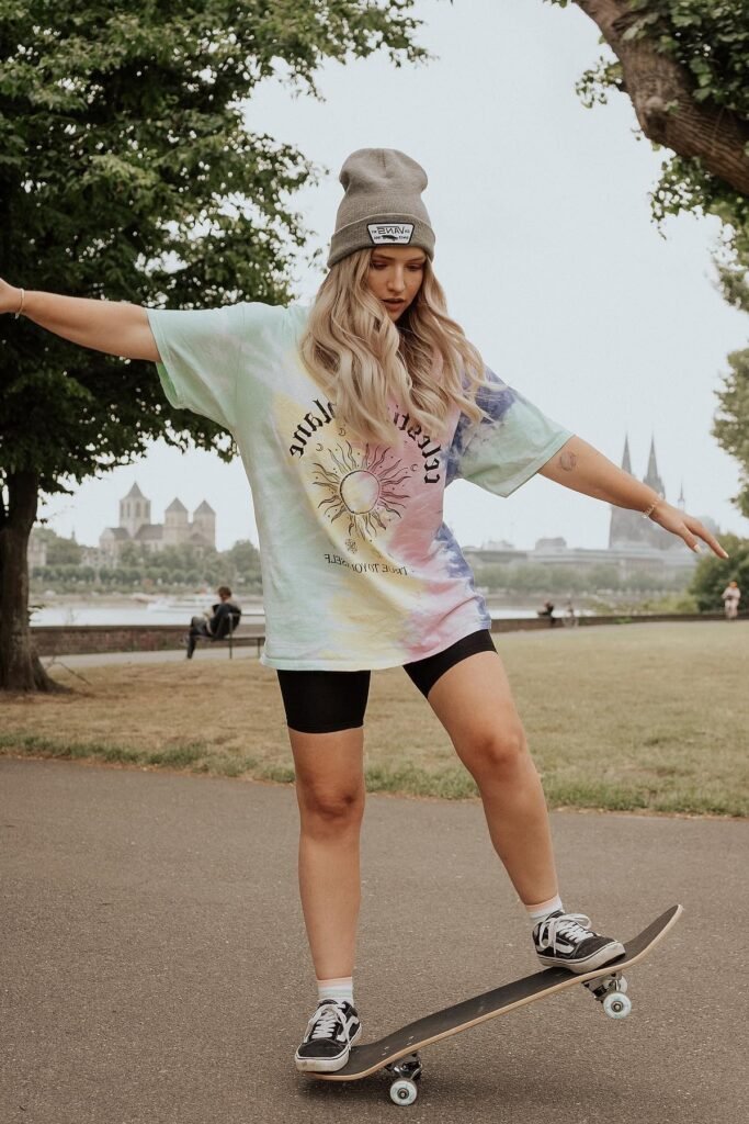 Oversized Tie-Dye Graphic T-shirt + Black Biker Shorts + Black and White Vans