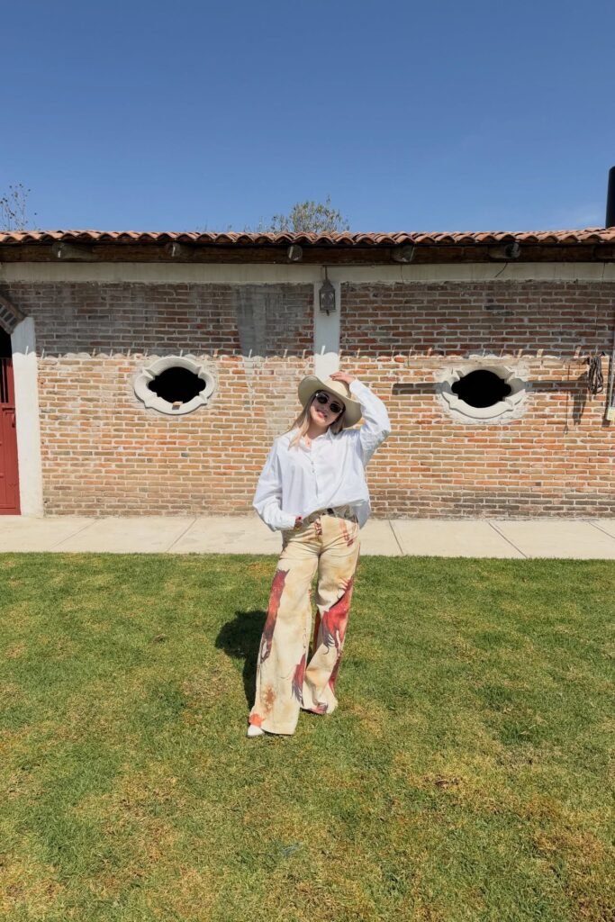 Oversized White Button-Down + Horse Print Wide-Leg Pants + Beige Cowboy Hat
