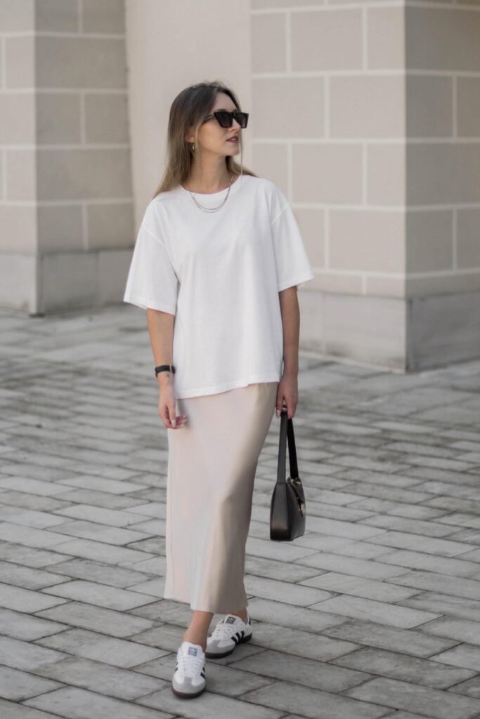 Oversized White T-Shirt + Cream Satin Maxi Skirt + White and Black Sneakers