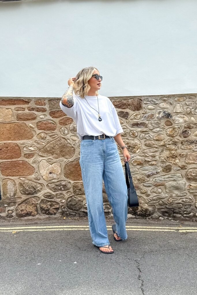 Oversized White T-shirt + Light Wash Baggy Jeans + Black Flip Flops