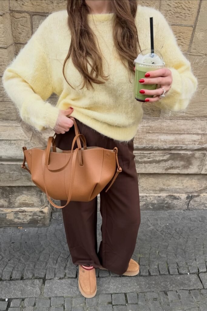 Pale Yellow Fluffy Knit Sweater + Deep Brown Wide-Leg Trousers + Tan Shearling Mules + Cognac Leather Tote Bag
