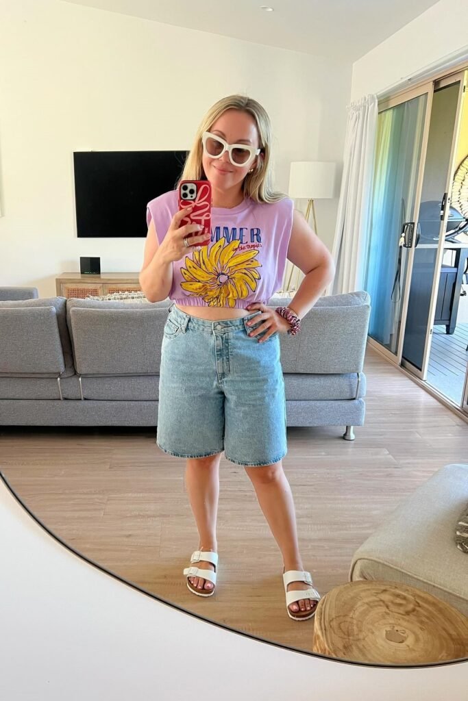 Purple Muscle Tee + Light Wash Denim Bermuda Shorts + White Two-Strap Sandals