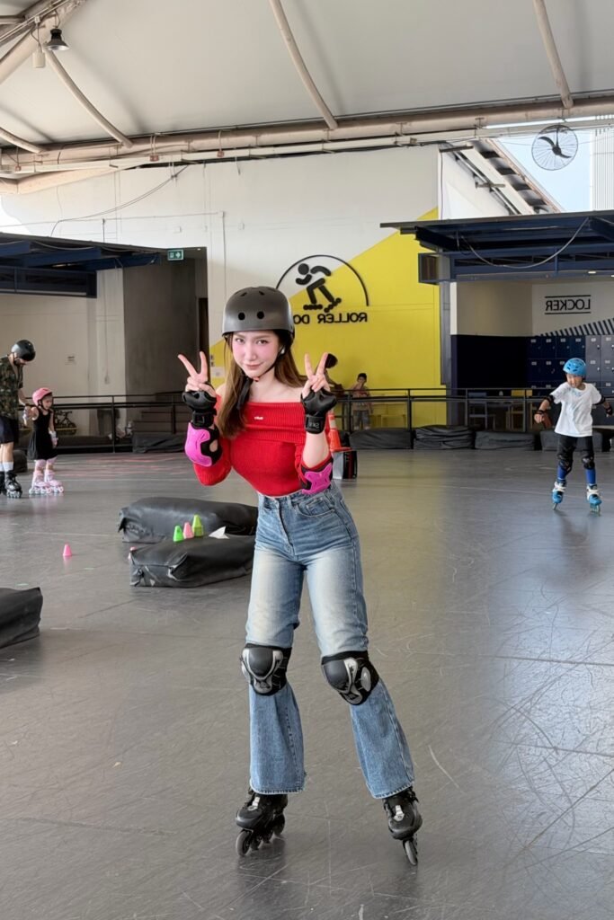 Red Off-the-Shoulder Top + Light Blue Flared Jeans + Black Inline Skates