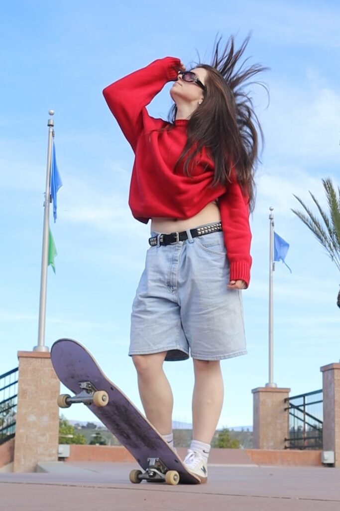 Red Oversized Sweater + Light Wash Denim Shorts + White Athletic Sneakers